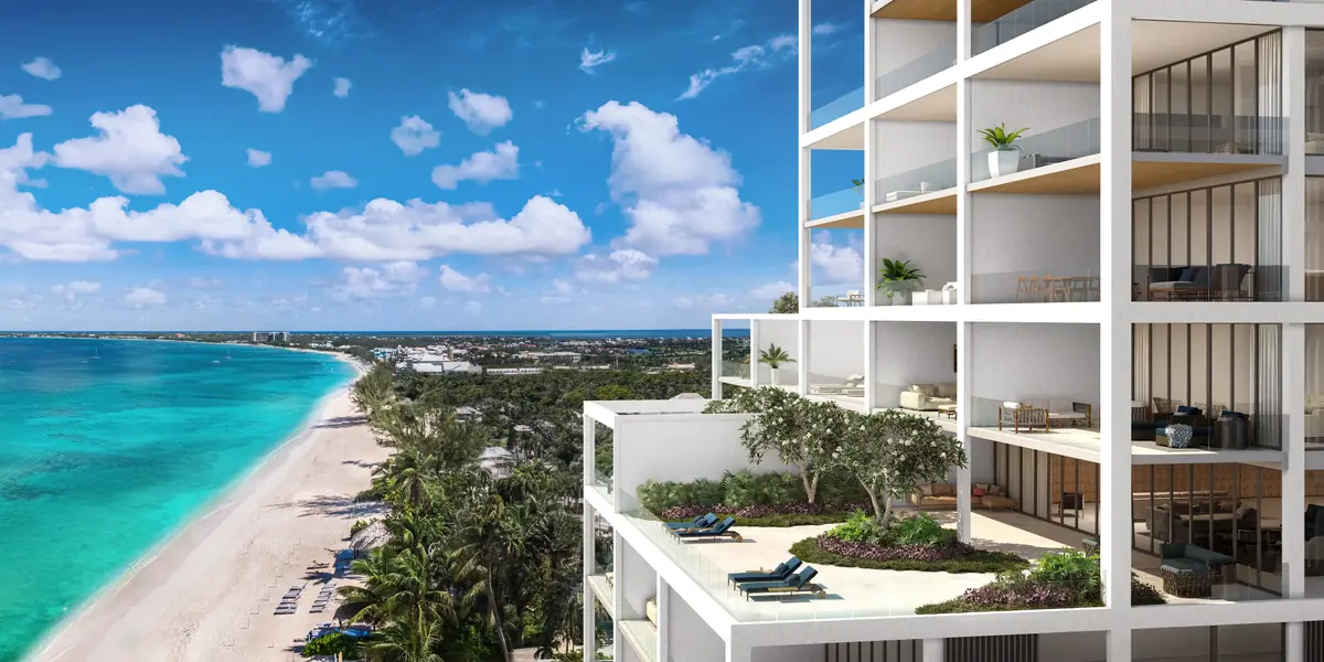 Aerial view of a residential building by a turquoise beach