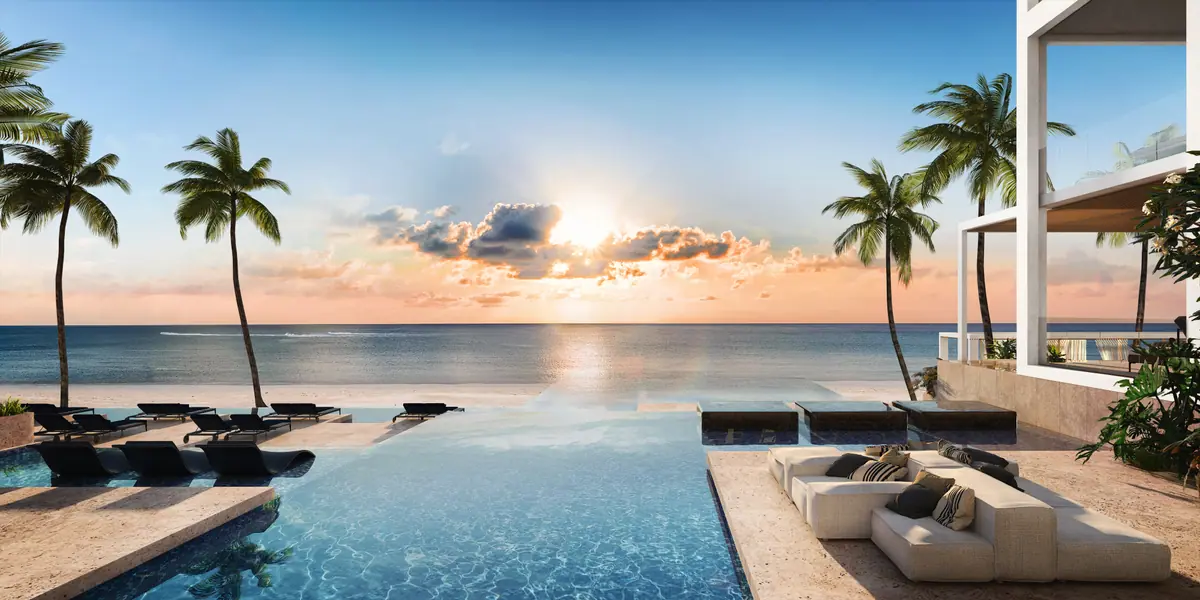 Infinity pool with palm trees at sunrise