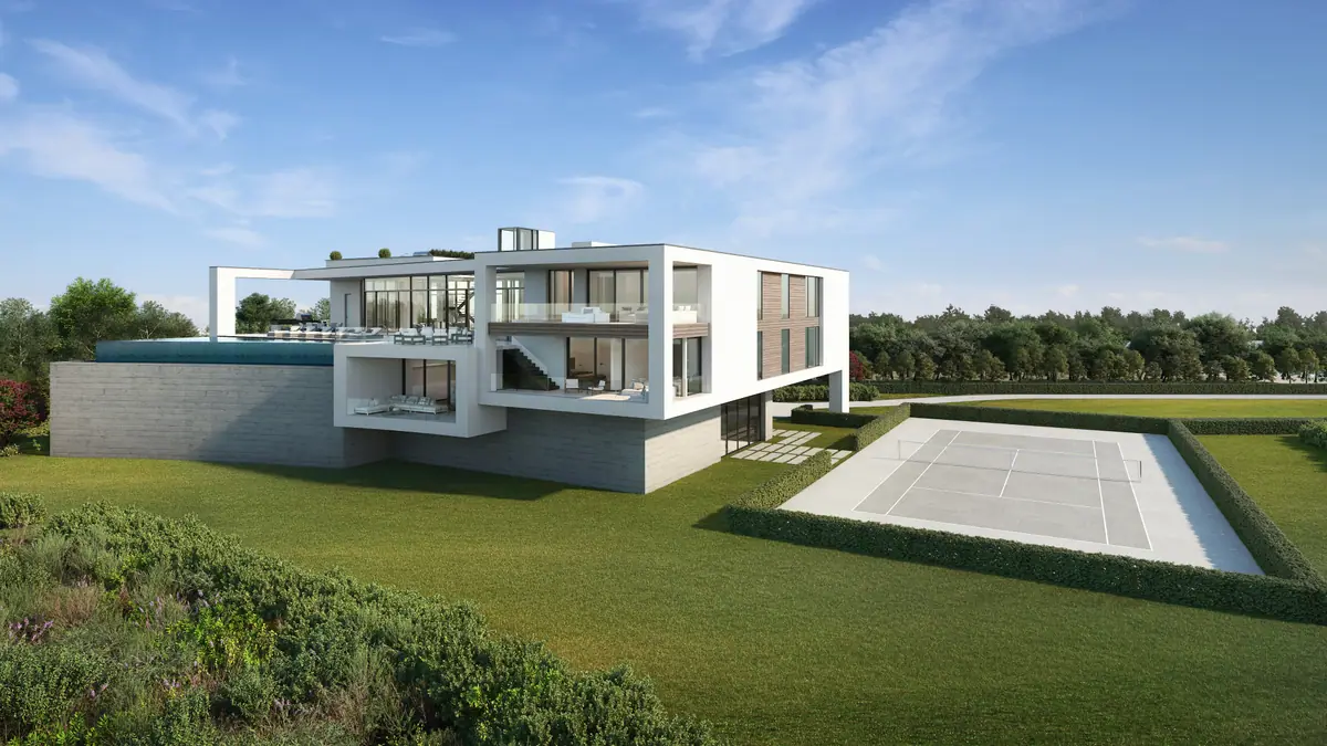 White contemporary house on a lawn with tennis court
