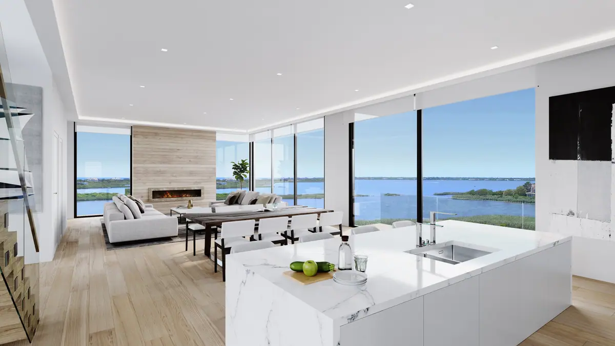 Open living room with white kitchen and bay view