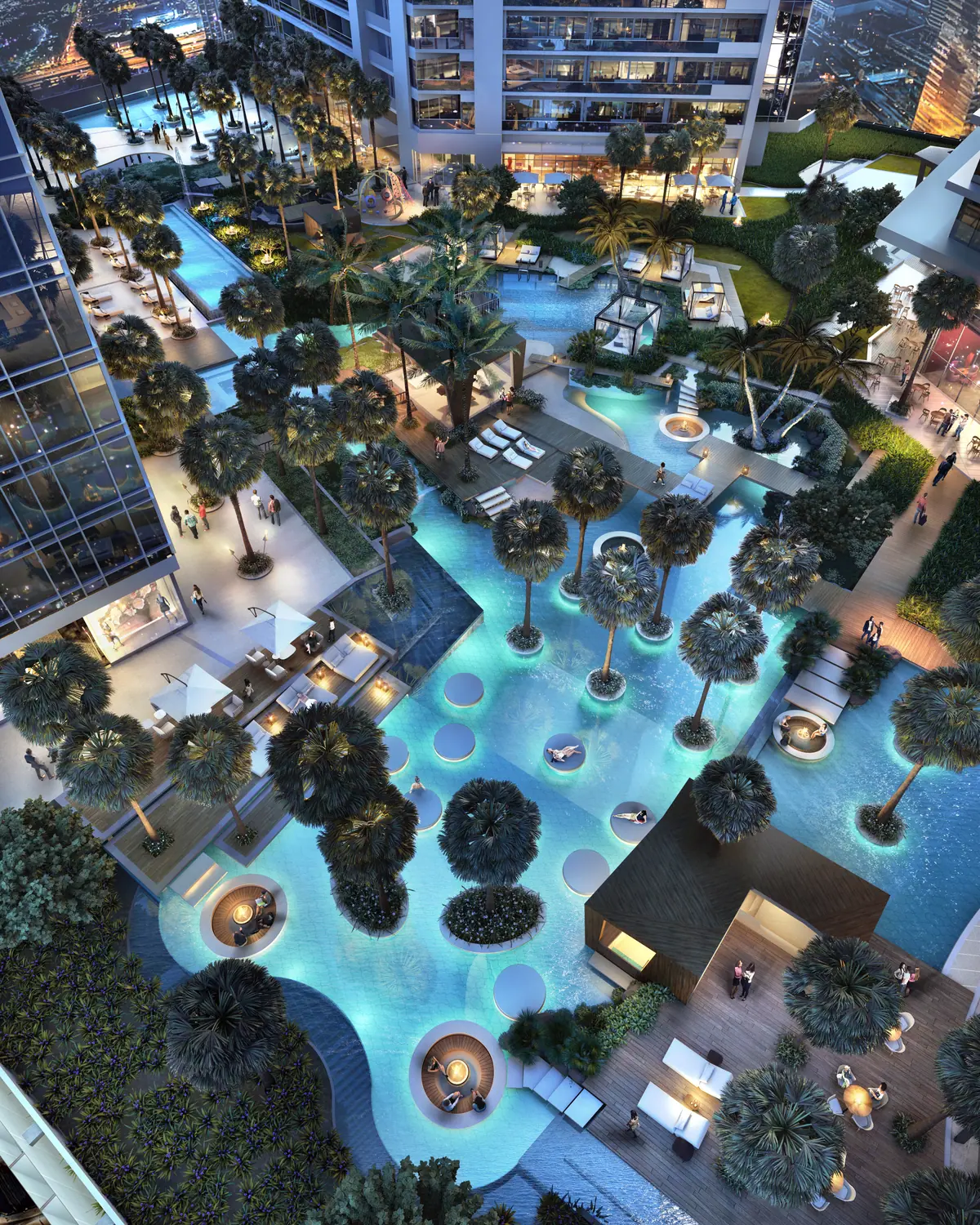 Aerial night view of a leisure deck with water features and palms