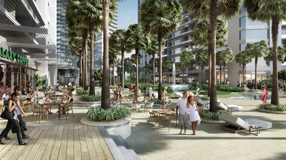 Boulevard with cafés, palm trees and residential towers
