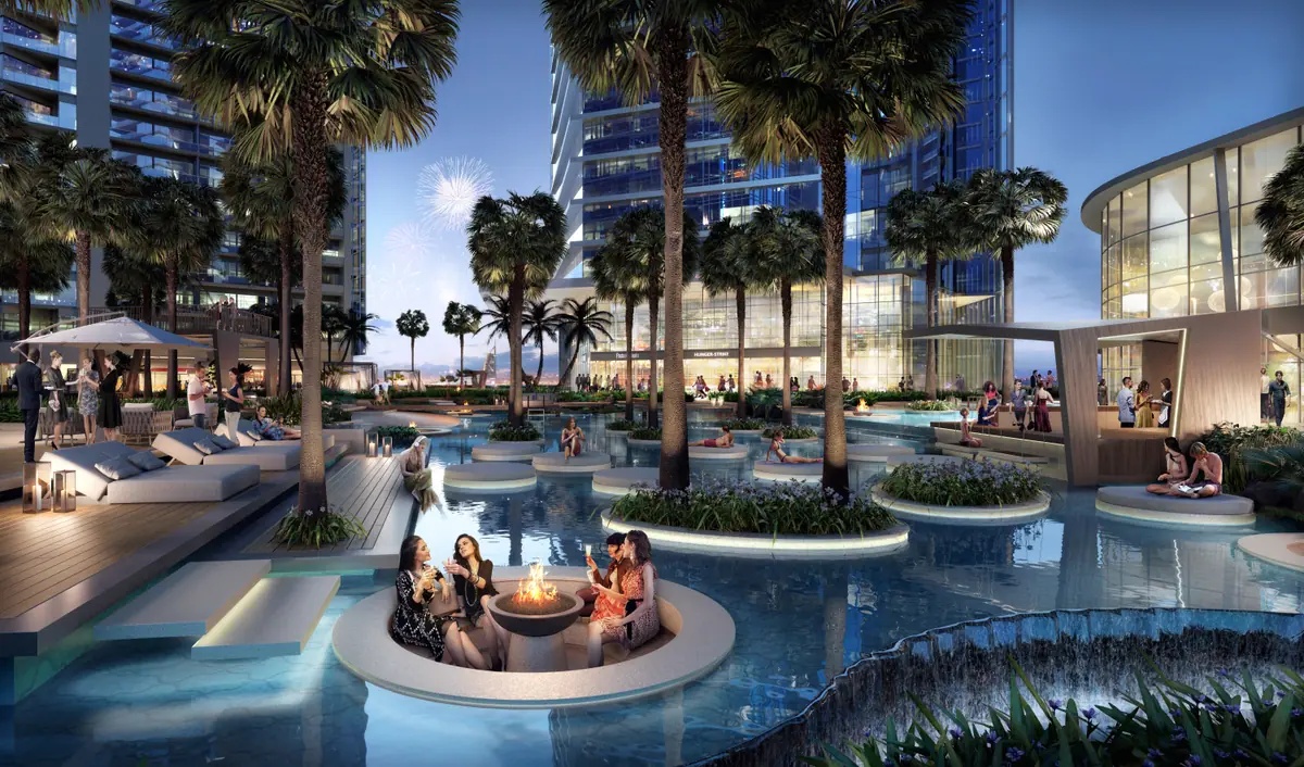 Pool with fire lounge at dusk between towers